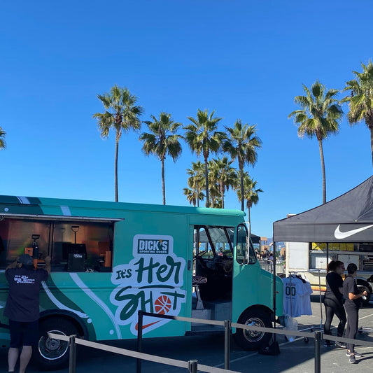 A colorful vinyl wrap for a Nike Campaign on Venice Beach, in Los Angeles, CA live screen printing and customizing t-shirts for guests of a high profile marketing, advertising product release campaign.