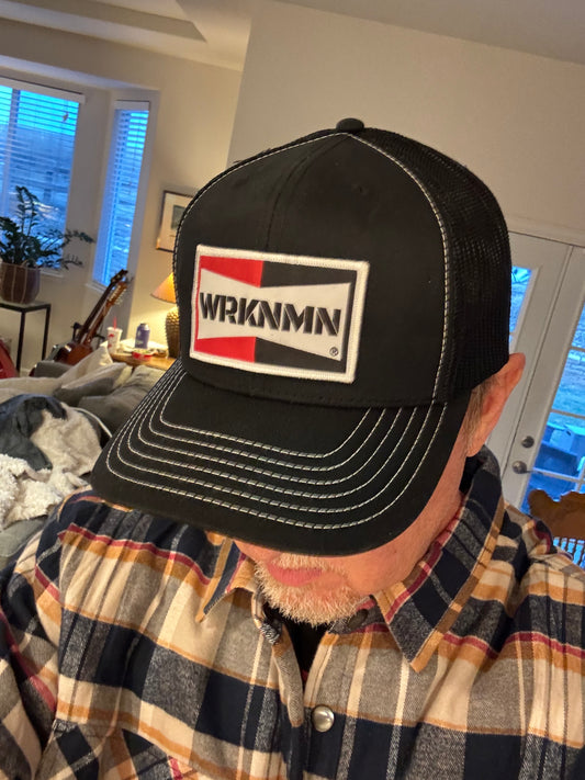 A hard working man wearing his classic WRKNMN truckers hat.