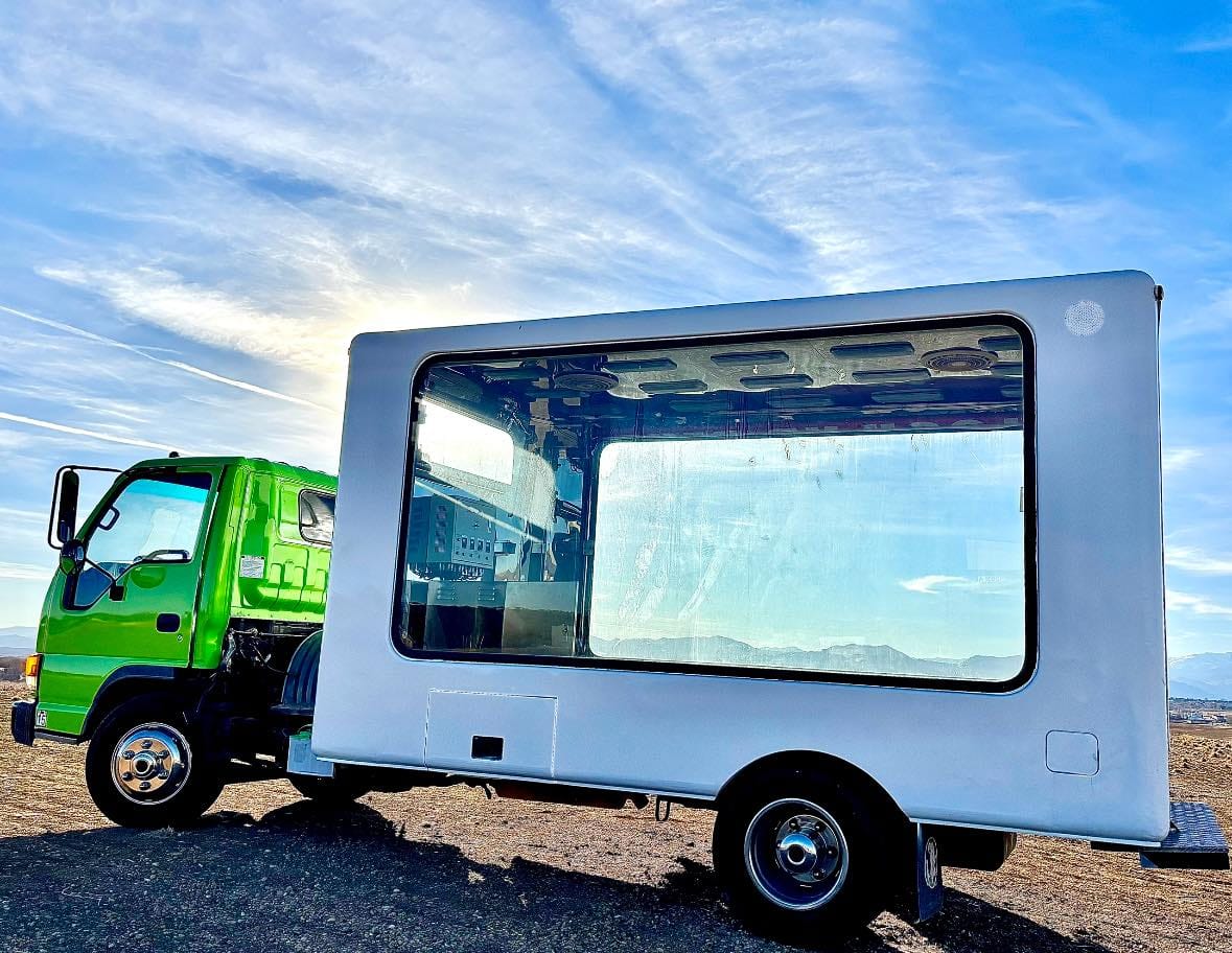An experiential marketing glass box truck on a bright sunny day in Los Angeles. 