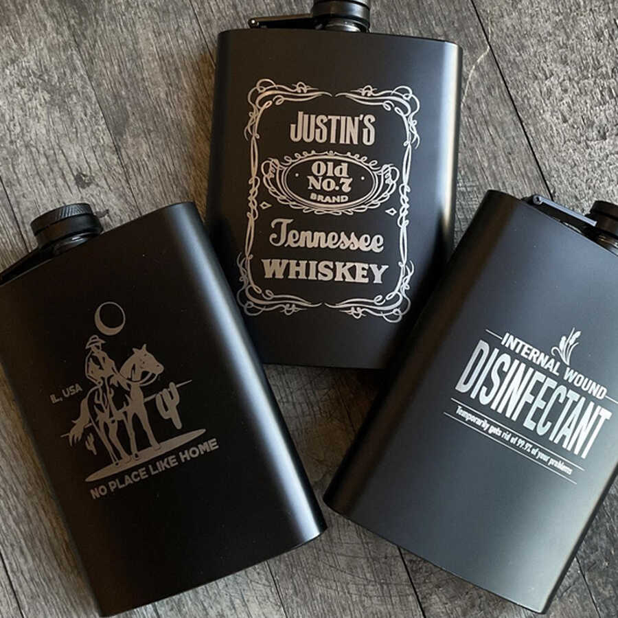 Live onsite laser etching & engraving on whiskey bottles at a event where guests get to choose what they want etched.