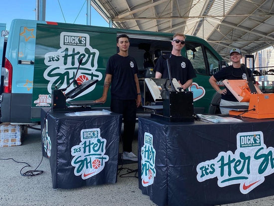 Three people live custom heat pressing for a Nike and Dick's Sporting Goods event in Brooklyn, New York.