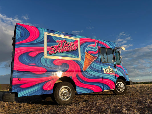 A picture of a vivid and bright ice cream truck that screen prints t-shirts named "Nice Dreams Ice Cream" and the paint job showcases blue and pink swirly background like melting ice cream.