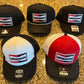 A collection of WRKNMN vintage retro trucker hats on display.